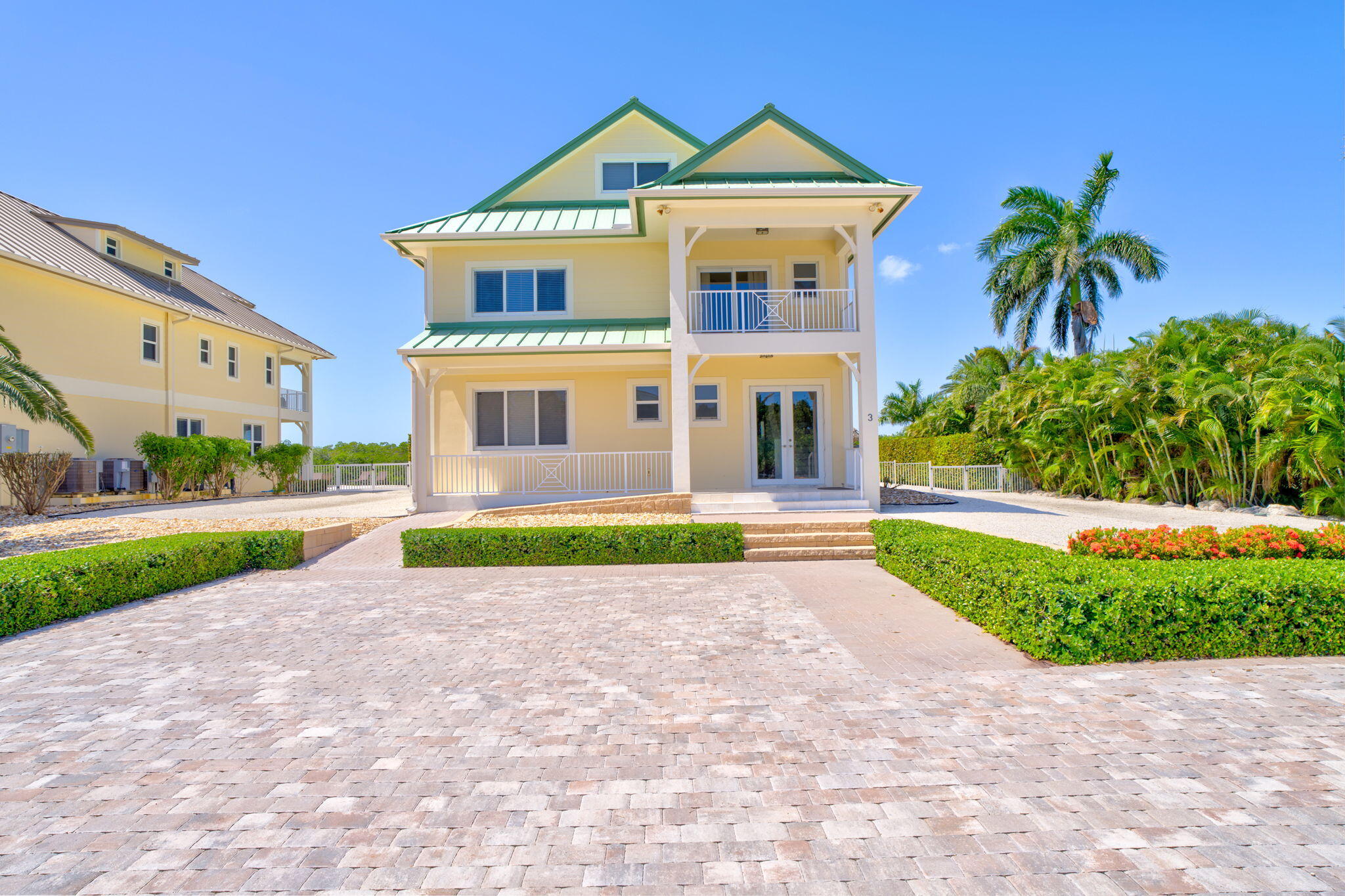 2394 Coco Plum Drive Marathon, FL 33050 - Photo 55 of 56 a front view of a house with a yard and garage