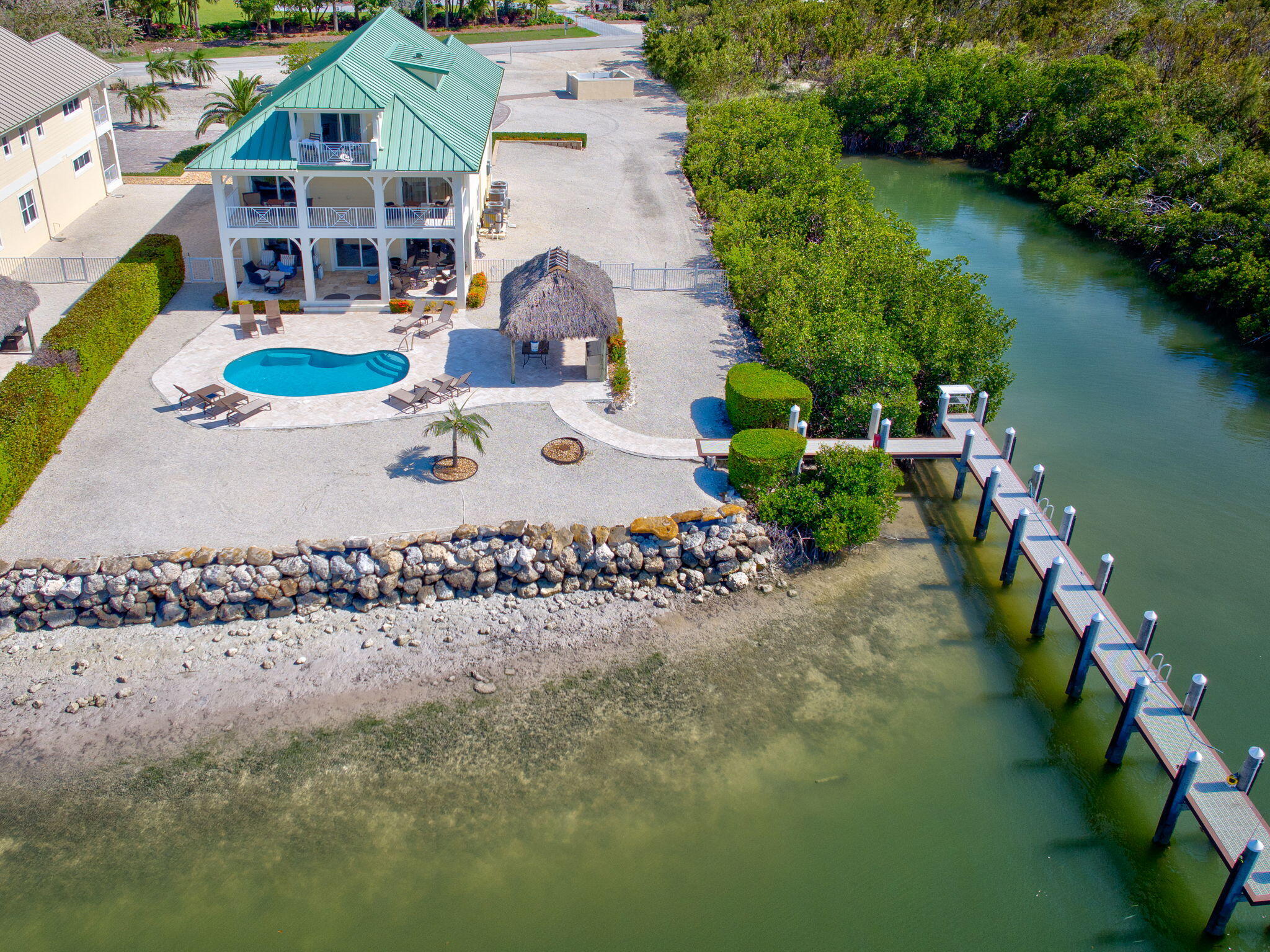 2394 Coco Plum Drive Marathon, FL 33050 - Photo 6 of 56 an aerial view of a house with a yard and lake view