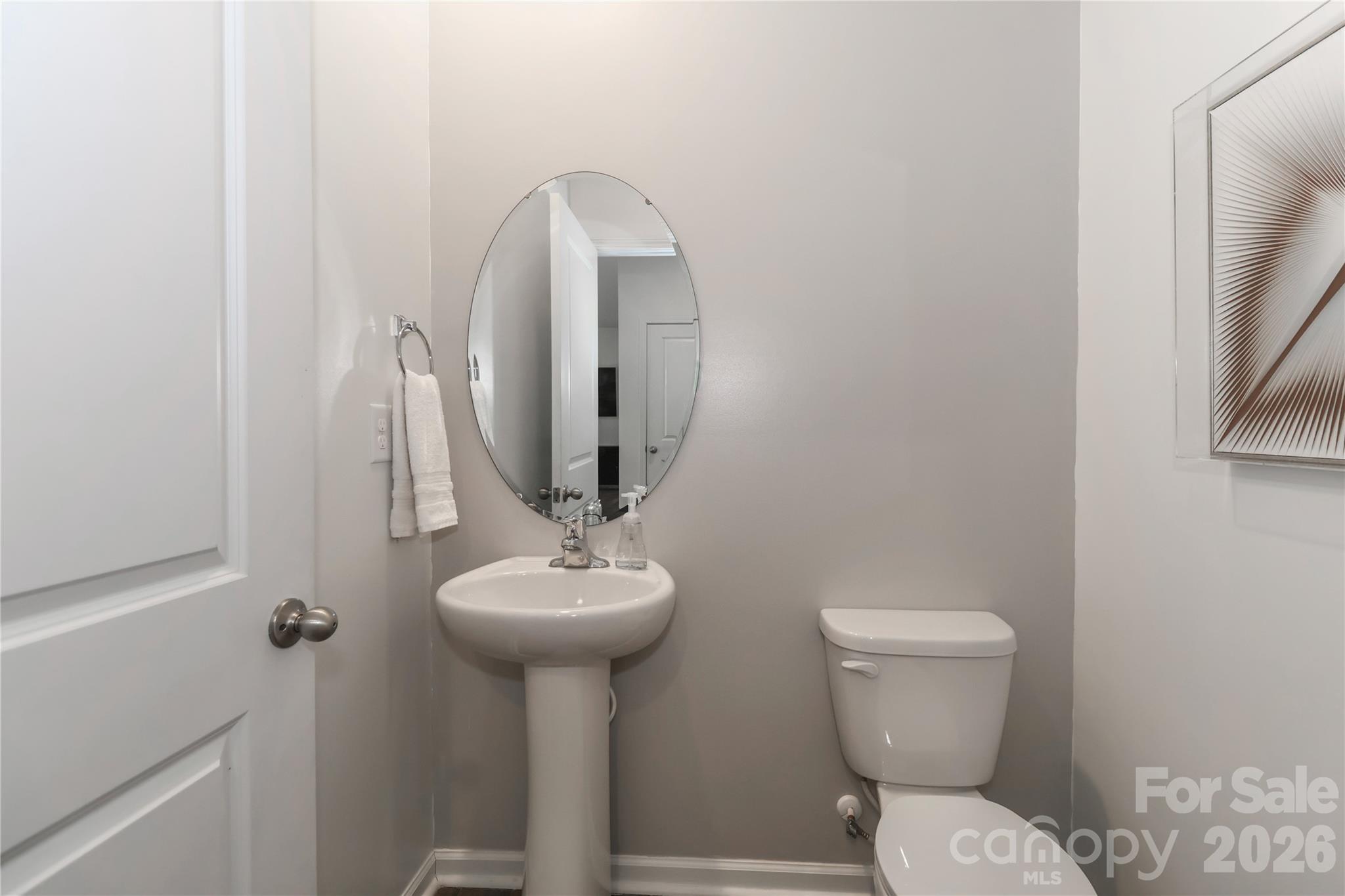 108 Kona Road, Unit 66 Mooresville, NC 28117 - Photo 20 of 47 a bathroom with a toilet sink and mirror