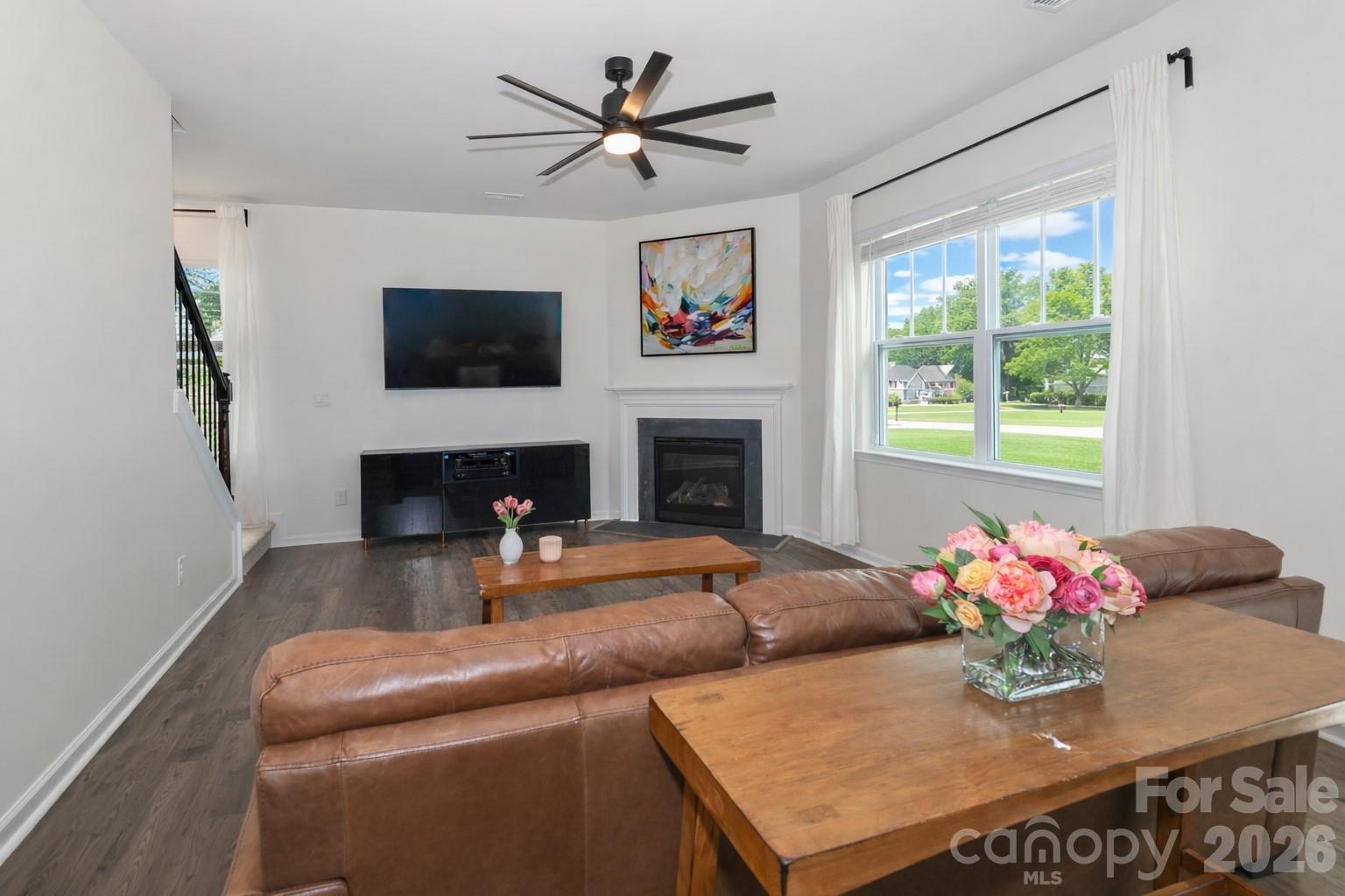 108 Kona Road, Unit 66 Mooresville, NC 28117 - Photo 21 of 47 a living room with furniture a fireplace and a flat screen tv
