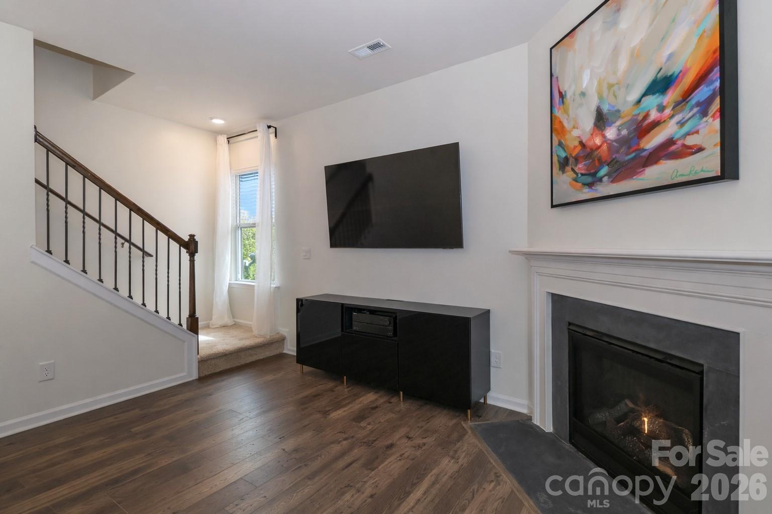108 Kona Road, Unit 66 Mooresville, NC 28117 - Photo 24 of 47 a living room with a fireplace and a flat screen tv