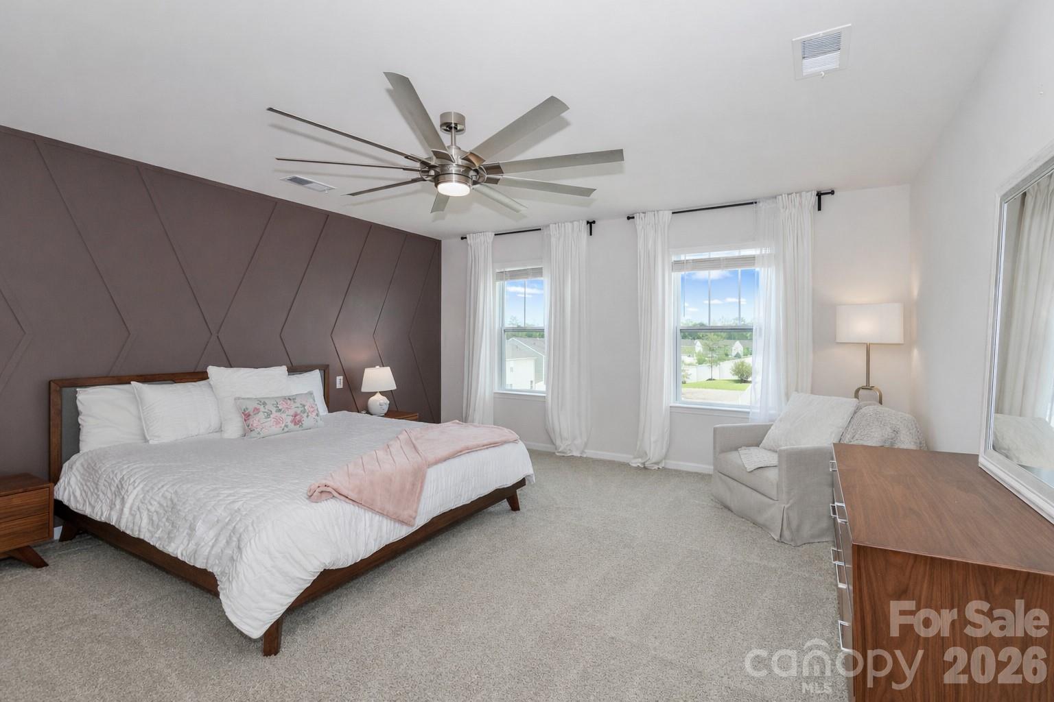 108 Kona Road, Unit 66 Mooresville, NC 28117 - Photo 27 of 47 a bedroom with a large bed and a chandelier