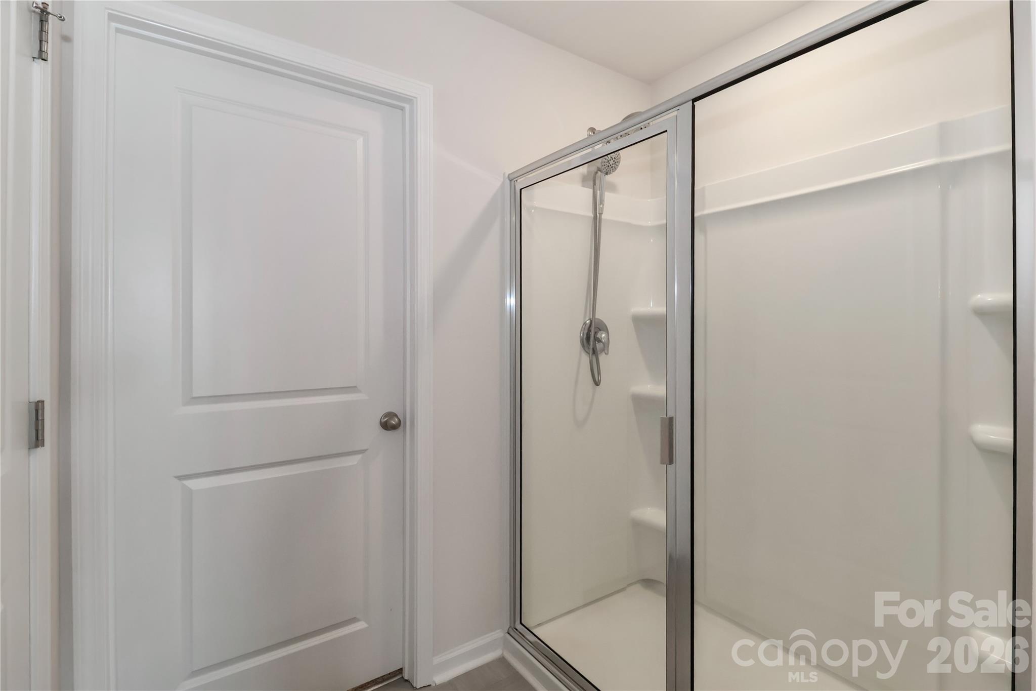 108 Kona Road, Unit 66 Mooresville, NC 28117 - Photo 30 of 47 a bathroom with a glass shower door