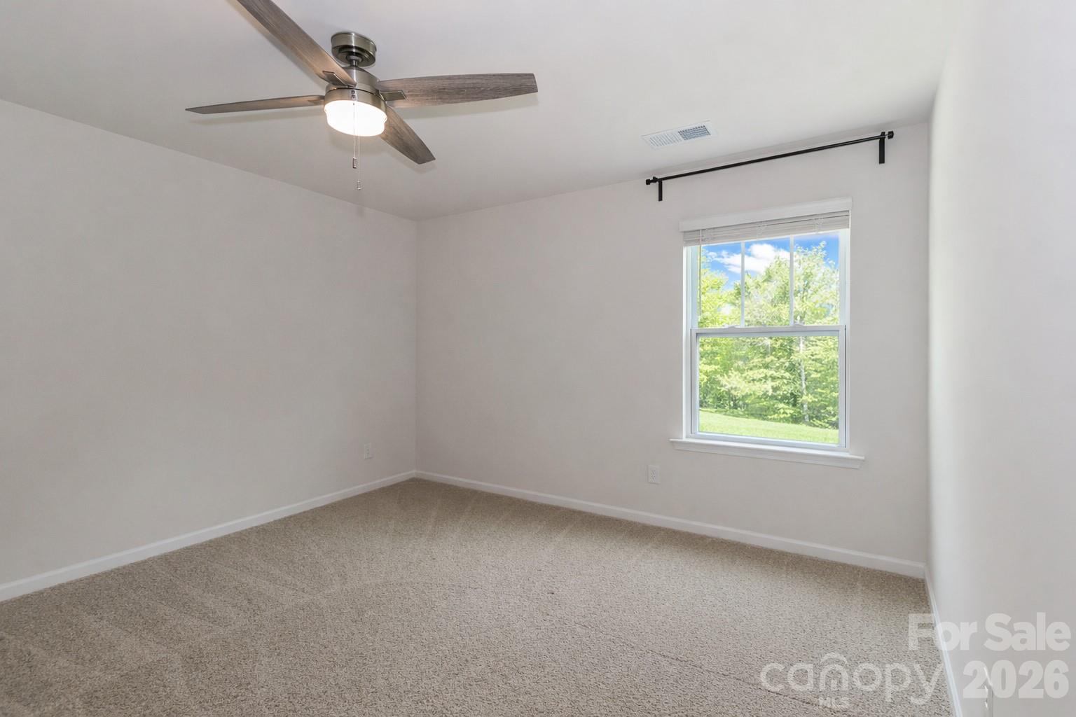 108 Kona Road, Unit 66 Mooresville, NC 28117 - Photo 33 of 47 an empty room with a window and a fan