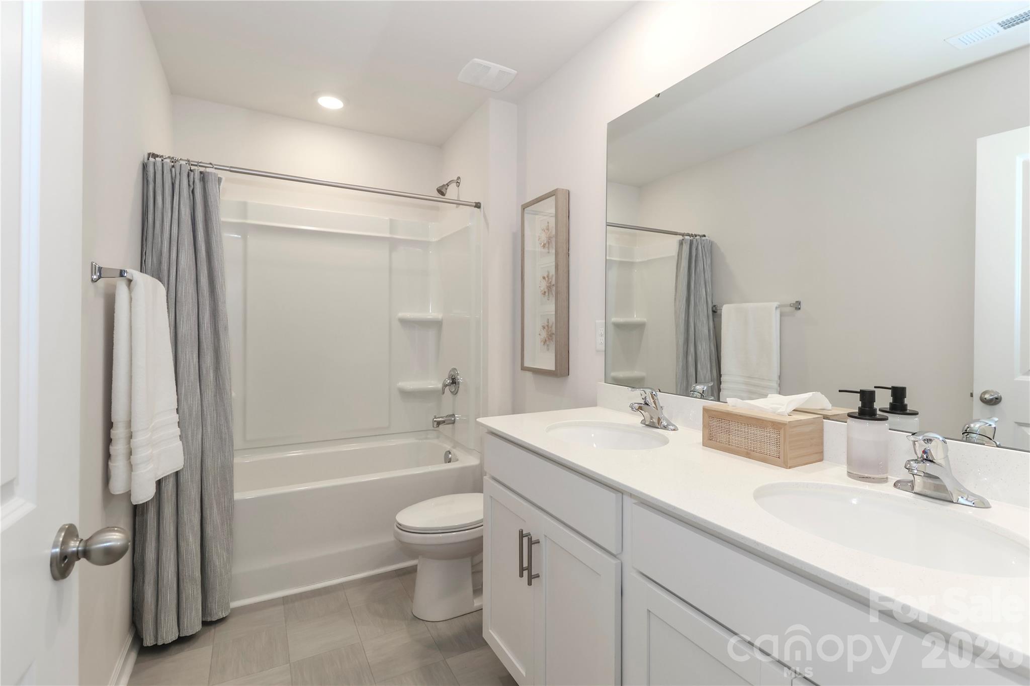 108 Kona Road, Unit 66 Mooresville, NC 28117 - Photo 35 of 47 a bathroom with a double vanity sink toilet mirror and shower