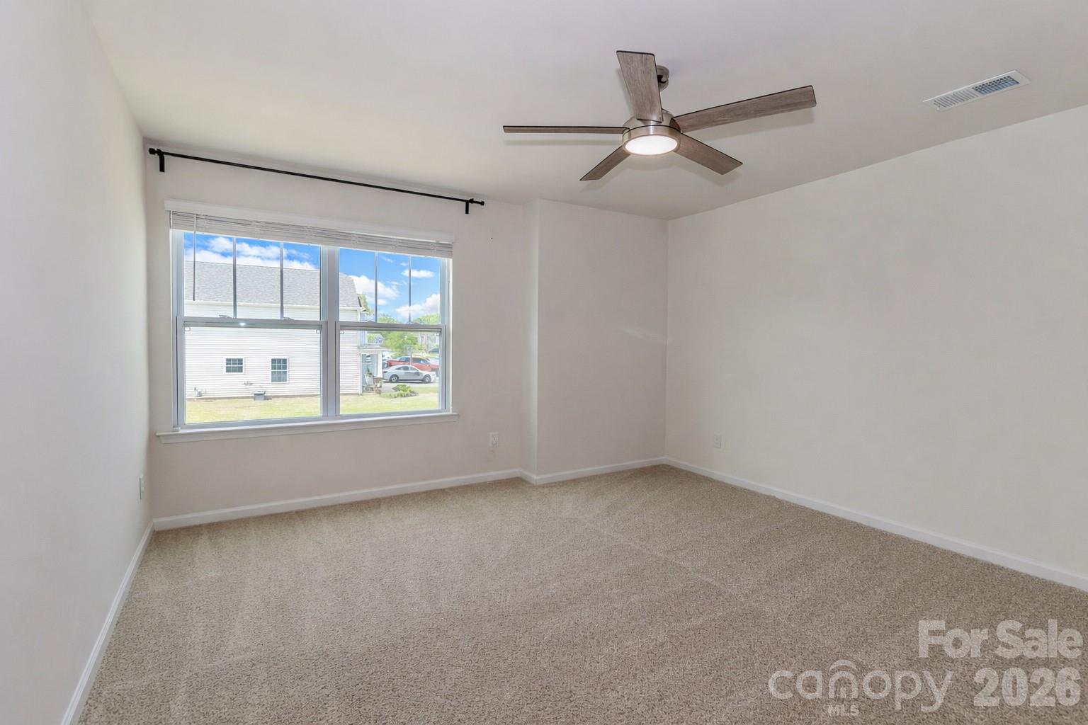 108 Kona Road, Unit 66 Mooresville, NC 28117 - Photo 36 of 47 an empty room with ceiling fan and windows