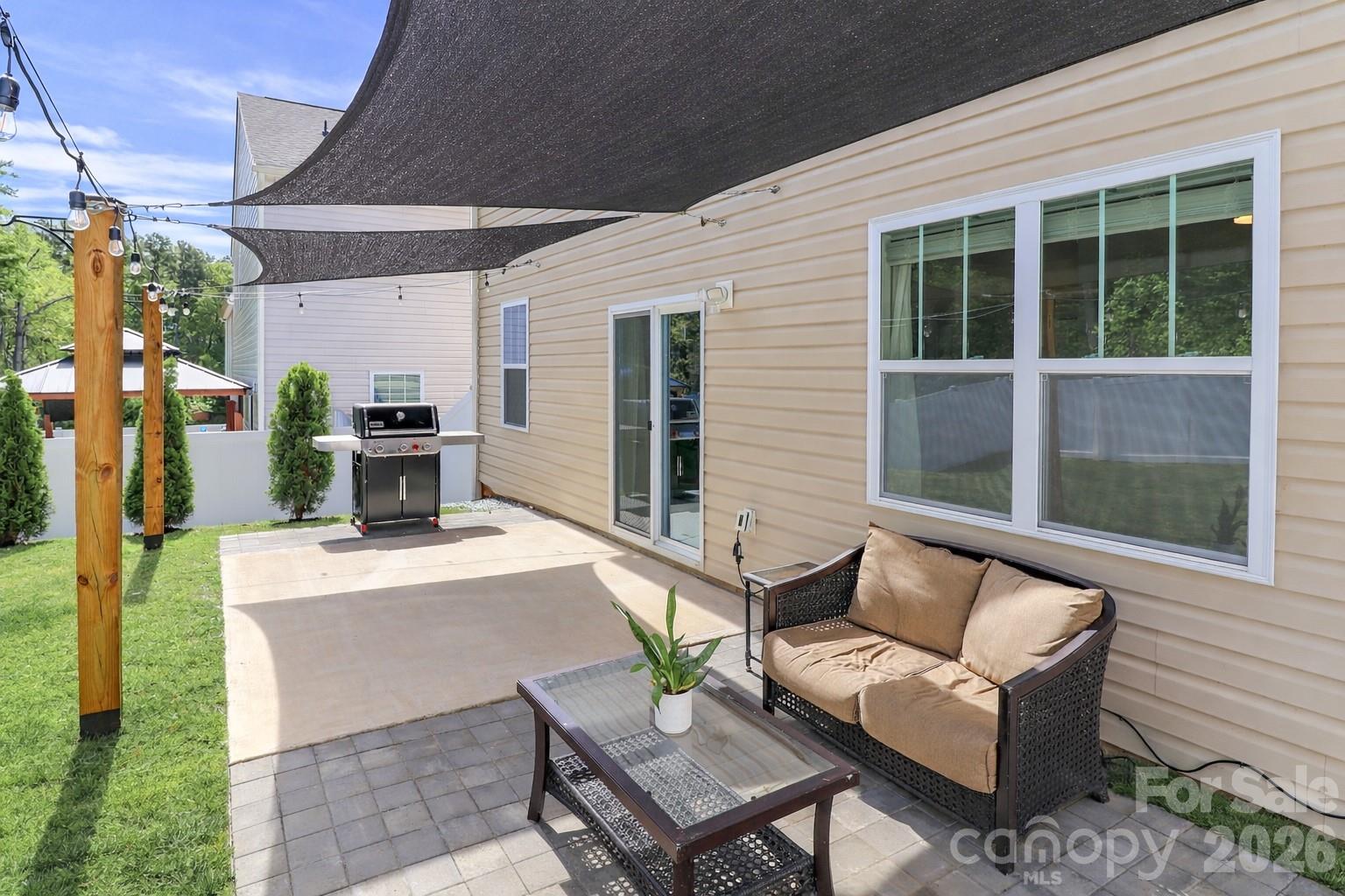 108 Kona Road, Unit 66 Mooresville, NC 28117 - Photo 45 of 47 a view of a patio with couches table and chairs with potted plants