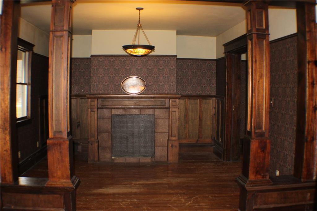 221 Ferguson Lane Perryopolis, PA 15473 - Photo 4 of 37 Living Room has wood floors, picture moulding and chandelier.