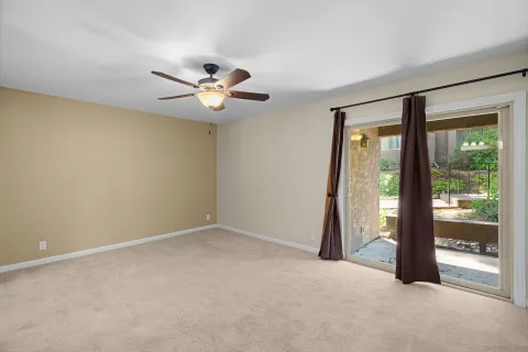 a view of a livingroom with a ceiling fan and window