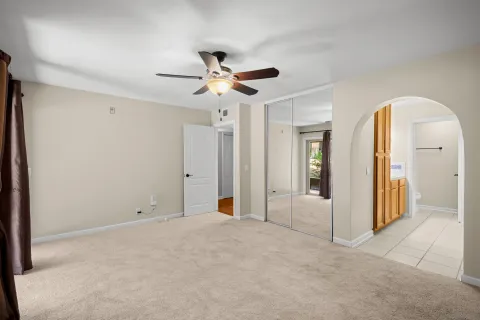 a view of a big room with closet area and ceiling fan