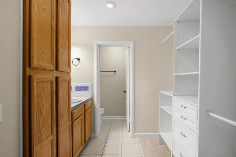 a view of a hallway with closet and front door