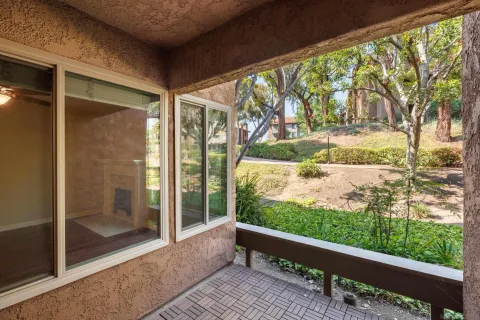 a view of a room with wooden floor and outdoor space