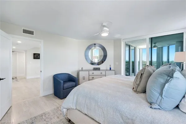 a bed room with a bed and a mirror
