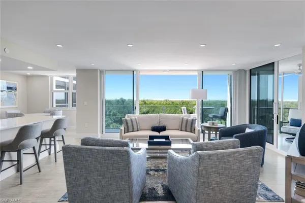 a living room with furniture and a large window