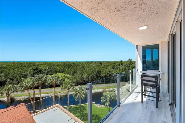 a view of a balcony with chairs