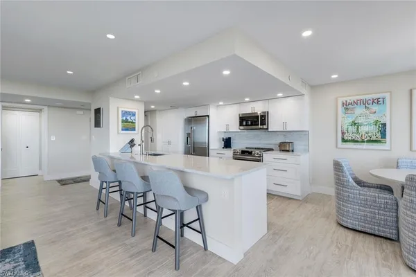 a kitchen with stainless steel appliances kitchen island granite countertop a sink and cabinets