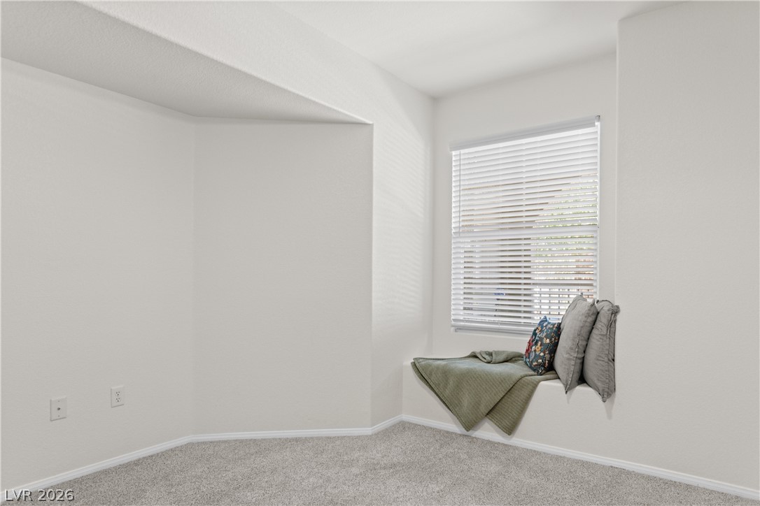 10550 West Alexander Road, Unit 1025 Las Vegas, NV 89129 - Photo 16 of 42 A cozy window seat offers a tranquil spot within this naturally illuminated room.