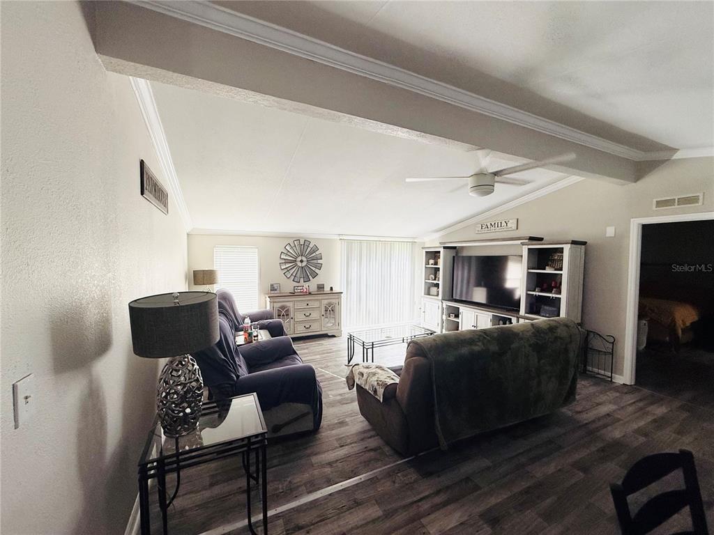 1475 Johnson Road Auburndale, FL 33823 - Photo 3 of 5 a living room with furniture a flat screen tv and a large window