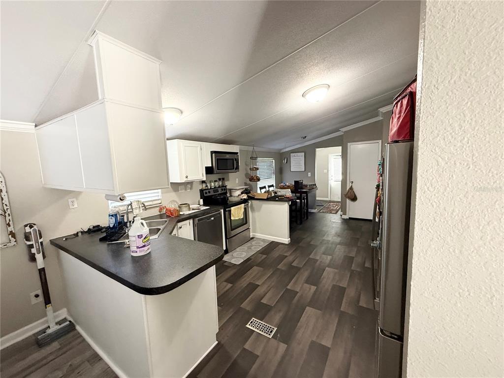 1475 Johnson Road Auburndale, FL 33823 - Photo 4 of 5 a kitchen with a sink appliances and cabinets