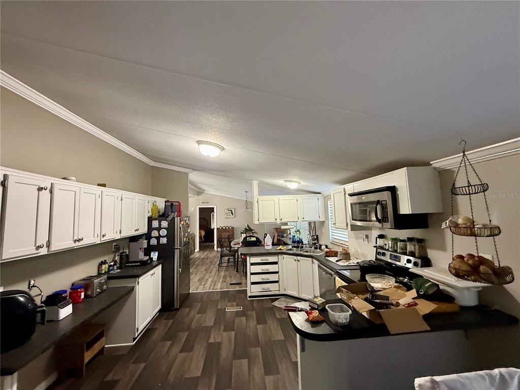 1475 Johnson Road Auburndale, FL 33823 - Photo 5 of 5 a kitchen with lots of counter top space appliances and cabinets