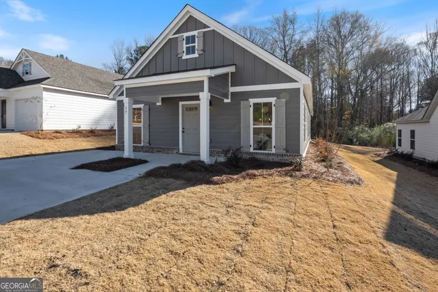 a front view of a house with a yard covered with snow and windows