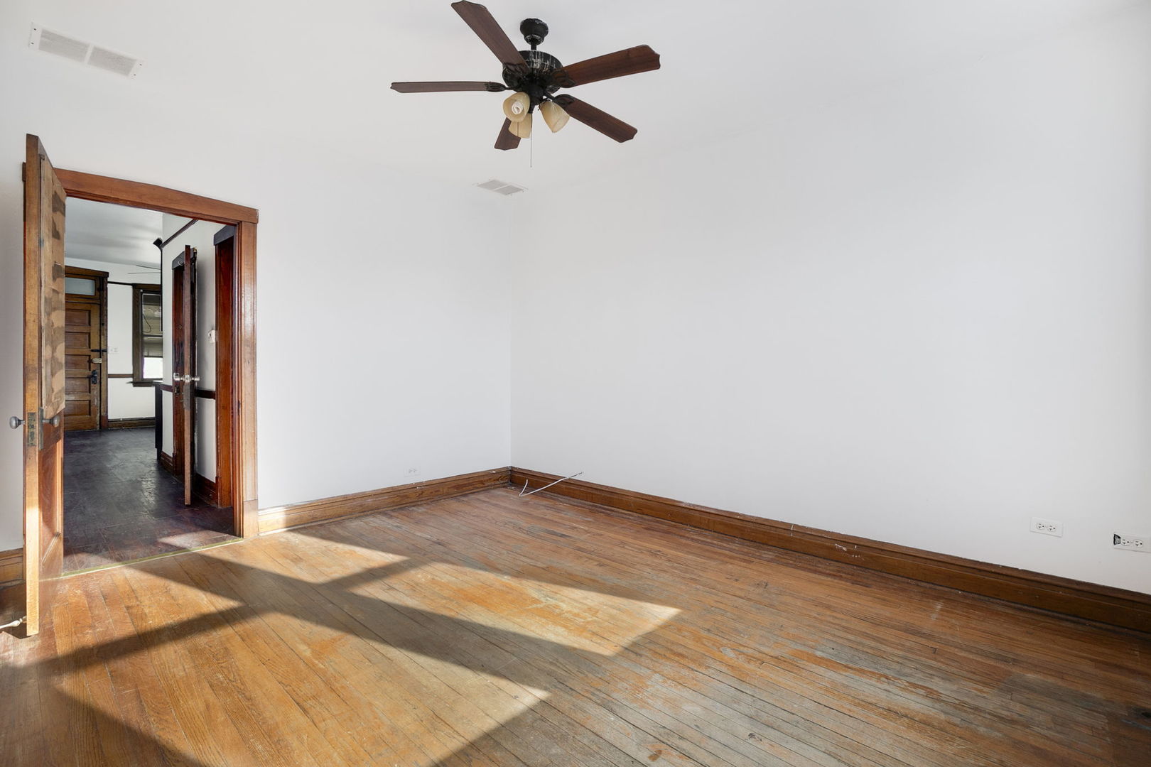 3128 West 41st Street Chicago, IL 60632 - Photo 11 of 36 a view of a room with wooden floor and a ceiling fan