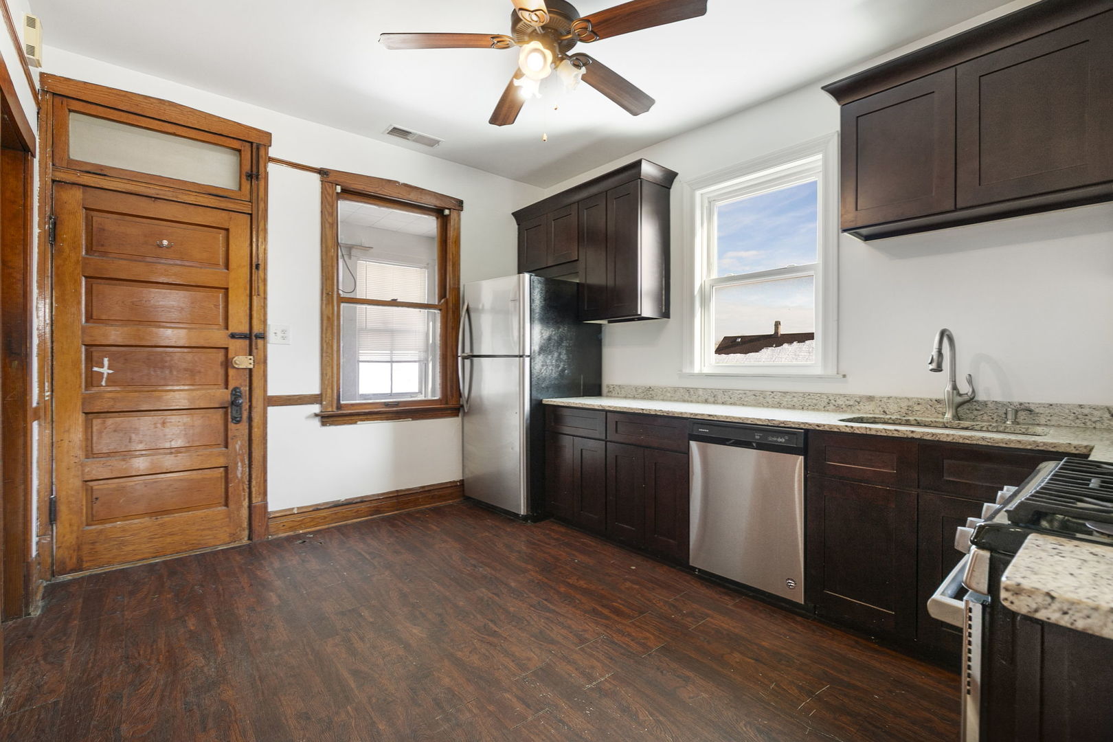 3128 West 41st Street Chicago, IL 60632 - Photo 13 of 36 a kitchen with stainless steel appliances granite countertop a sink cabinets and wooden floor