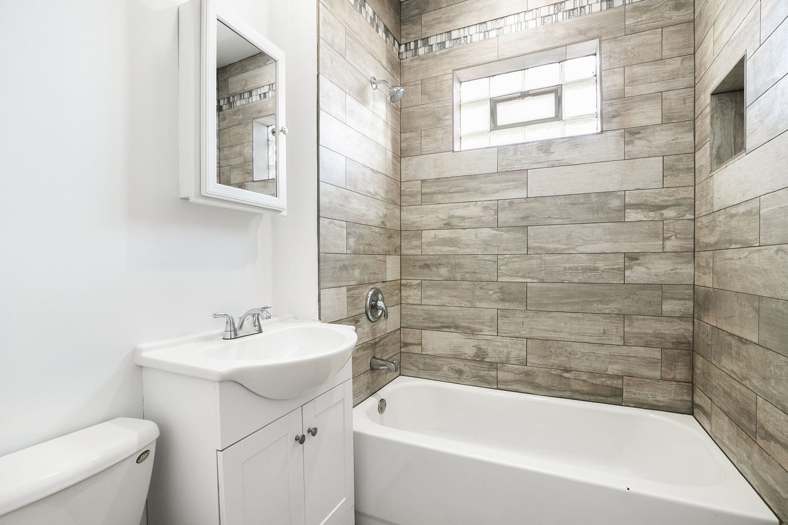 3128 West 41st Street Chicago, IL 60632 - Photo 21 of 36 a white bath tub sitting next to a white sink and a toilet