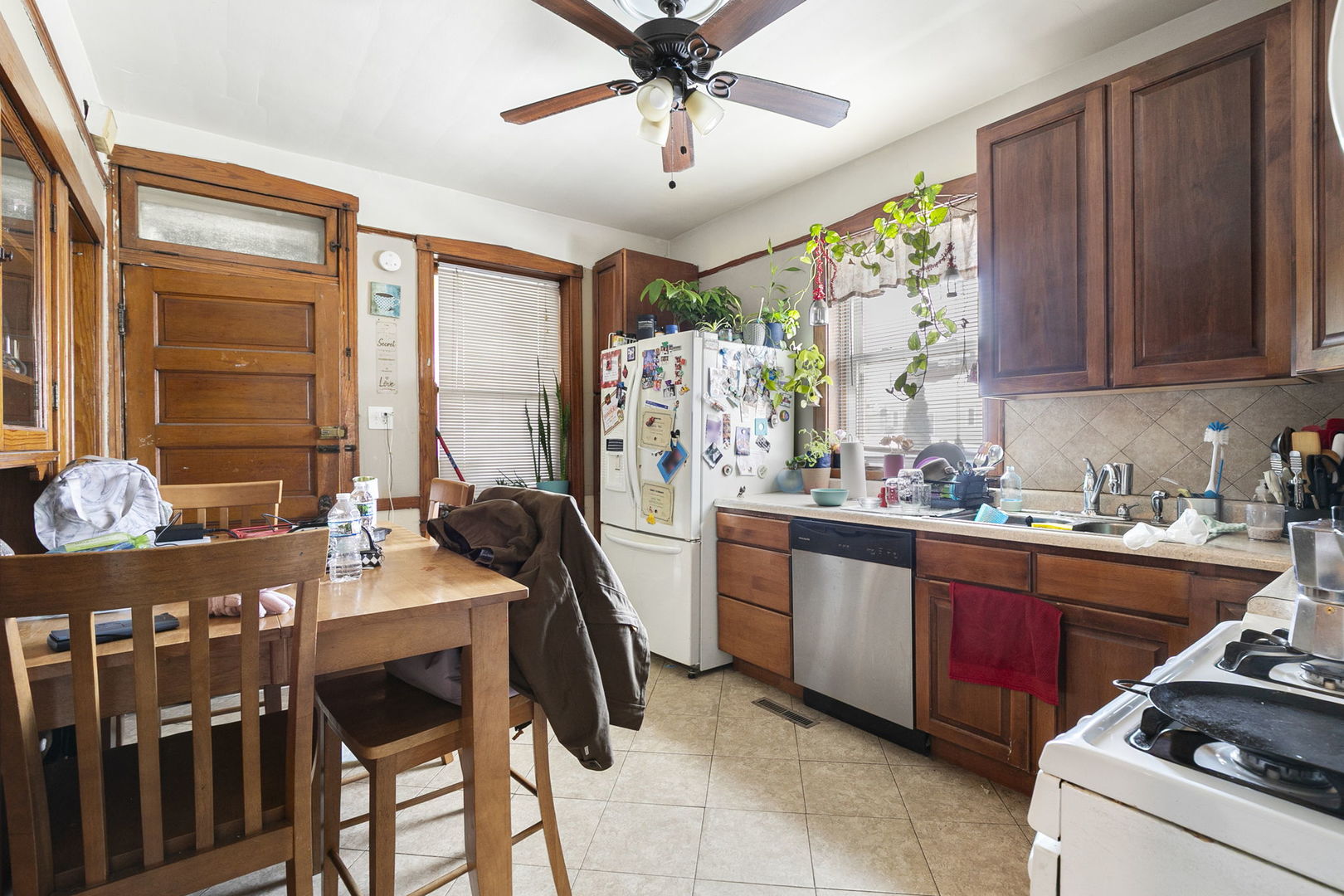3128 West 41st Street Chicago, IL 60632 - Photo 4 of 36 a kitchen with stainless steel appliances granite countertop a stove a sink dishwasher and a refrigerator with wooden cabinets
