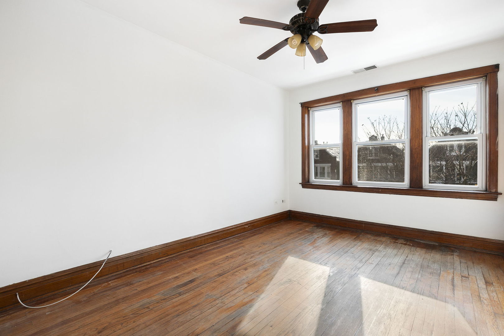 3128 West 41st Street Chicago, IL 60632 - Photo 10 of 36 a view of an empty room with a window and wooden floor