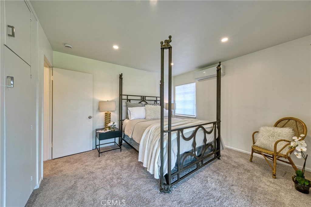2531 Calmia Road Duarte, CA 91010 - Photo 24 of 30 a spacious bedroom with a bed next to a window