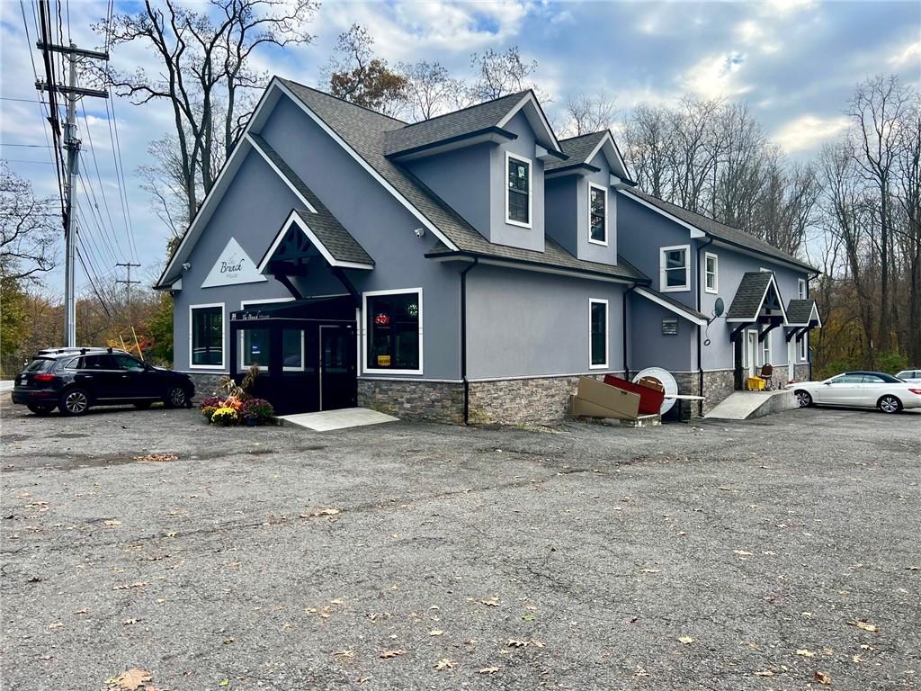 55 Secor Road, Unit 2 Mahopac, NY 10541 - Photo 1 of 1 a view of a house with a yard and a car parked in front of it
