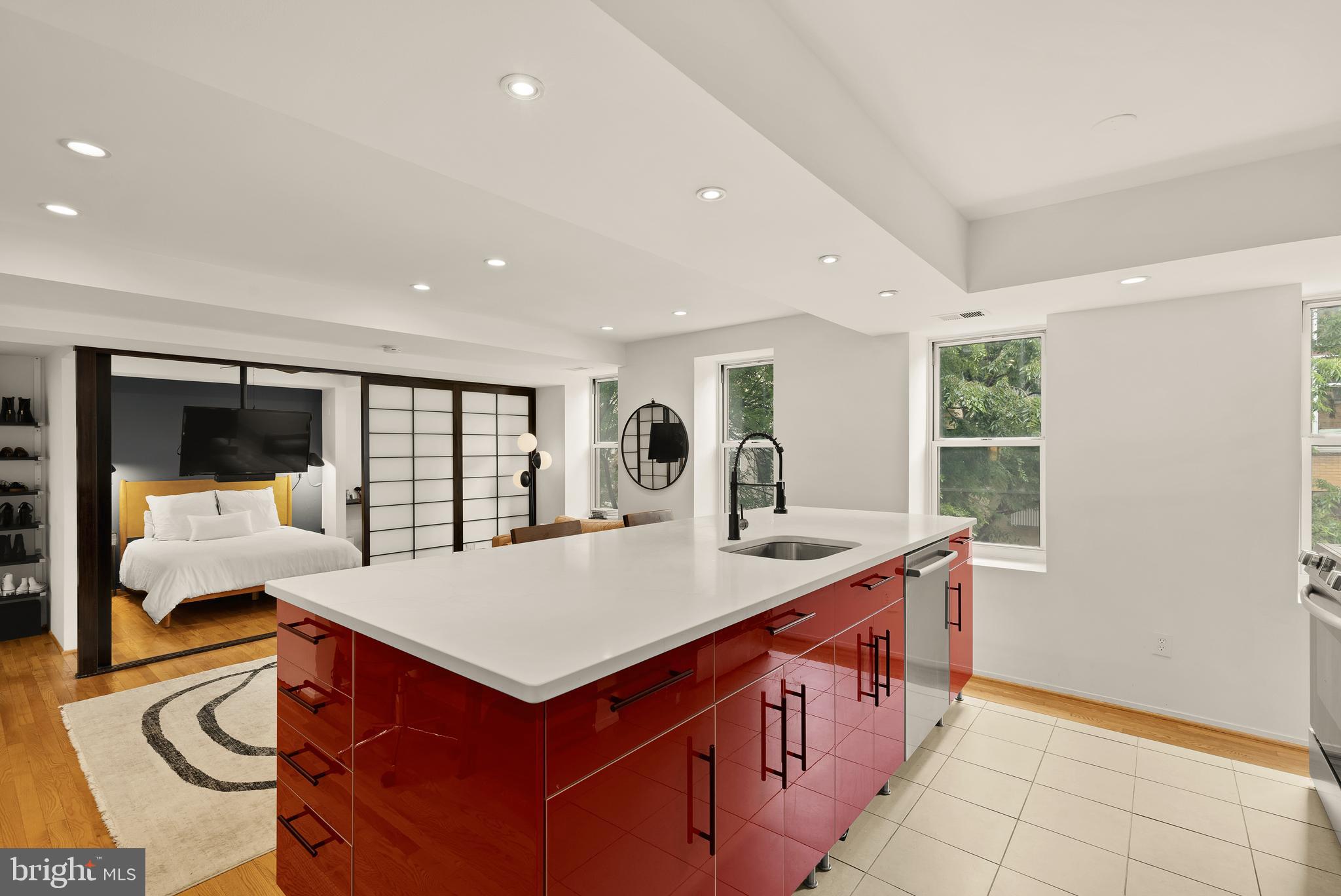 2370 Champlain Street Northwest, Unit 21 Washington, DC 20009 - Photo 4 of 22 a large kitchen with kitchen island a sink table and chairs