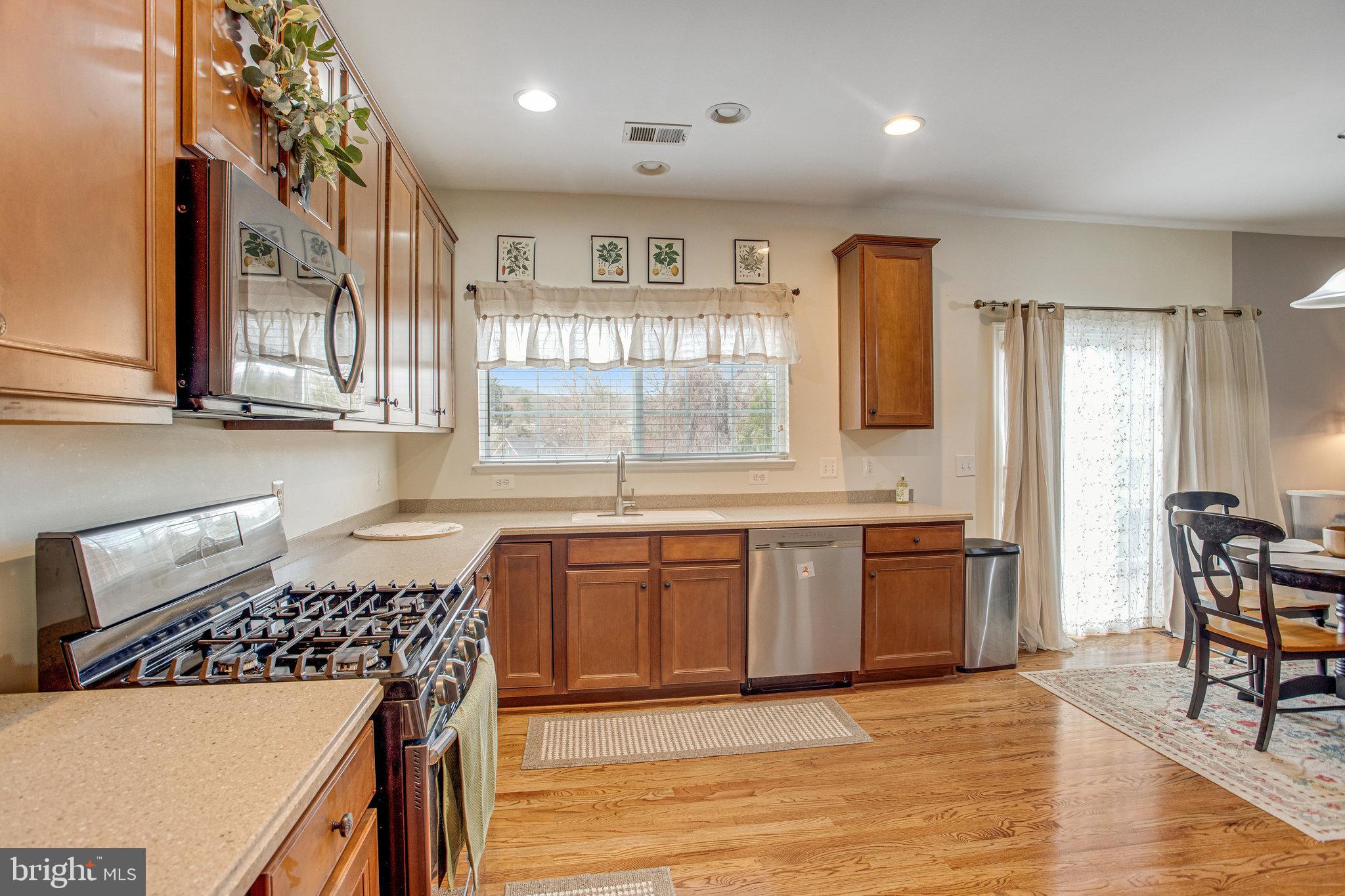 4287 Meyers Road Triangle, VA 22172 - Photo 11 of 51 a kitchen with stainless steel appliances granite countertop a stove a sink and a refrigerator