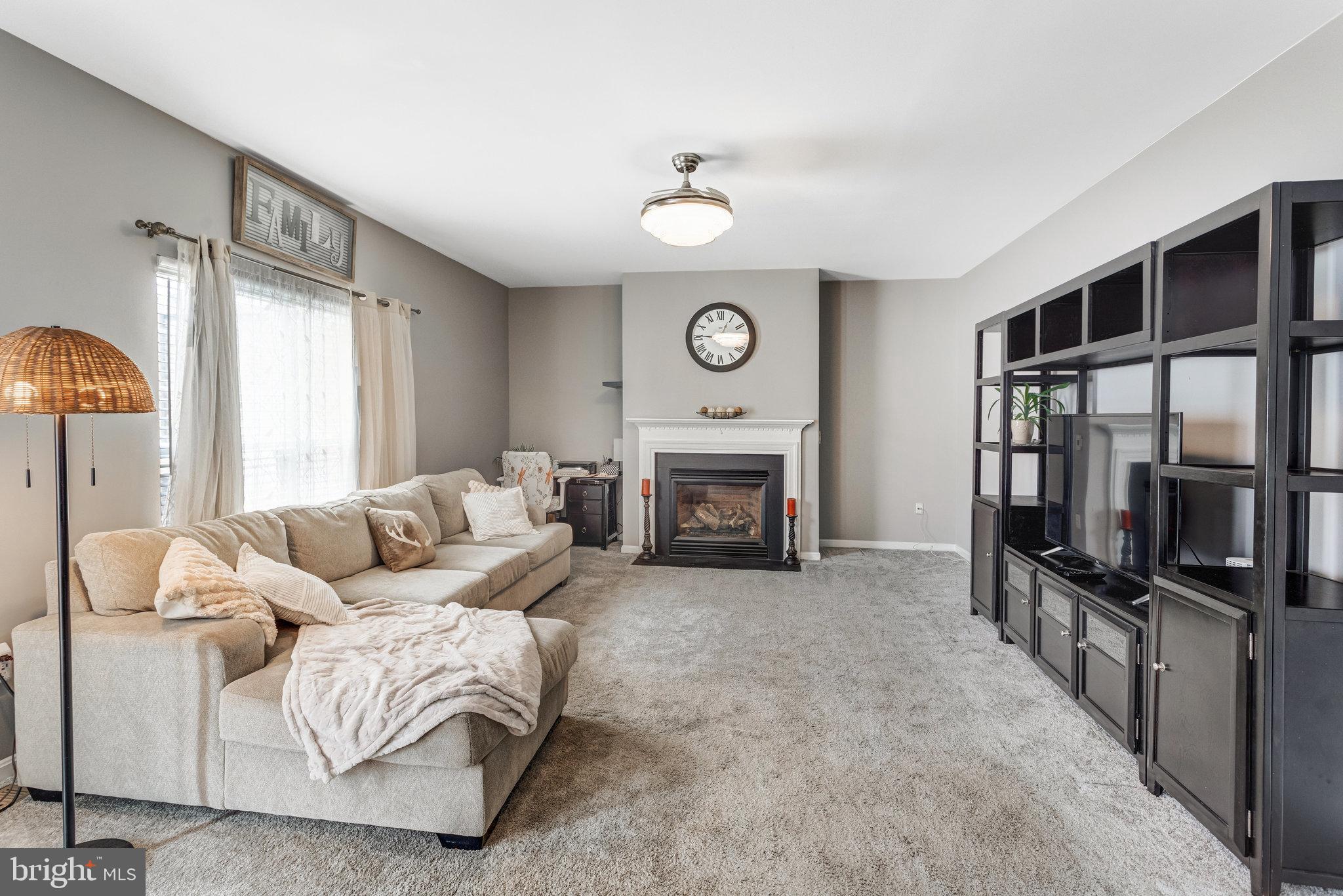 4287 Meyers Road Triangle, VA 22172 - Photo 17 of 51 a living room with furniture a fireplace and a large window