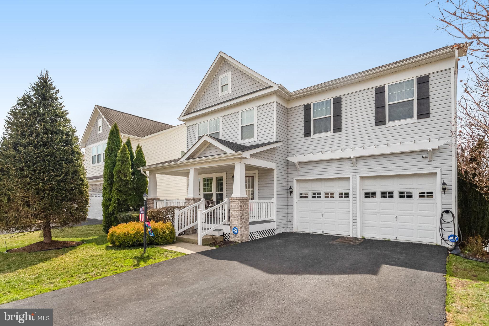4287 Meyers Road Triangle, VA 22172 - Photo 2 of 51 a front view of a house with a yard and garage