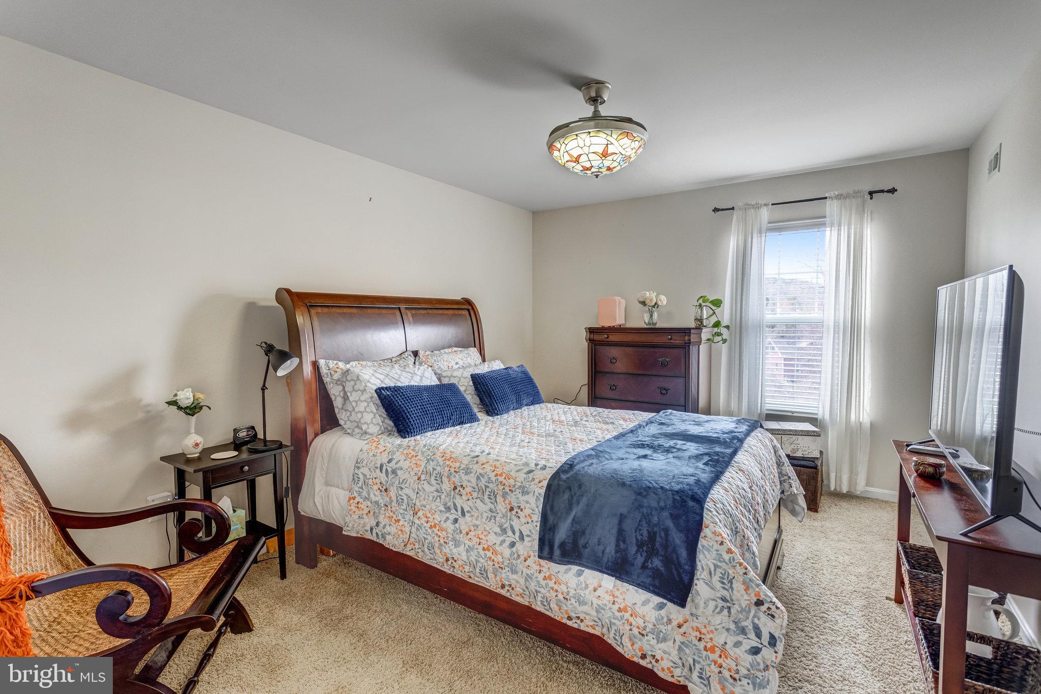 4287 Meyers Road Triangle, VA 22172 - Photo 22 of 51 a bedroom with a bed and a chandelier