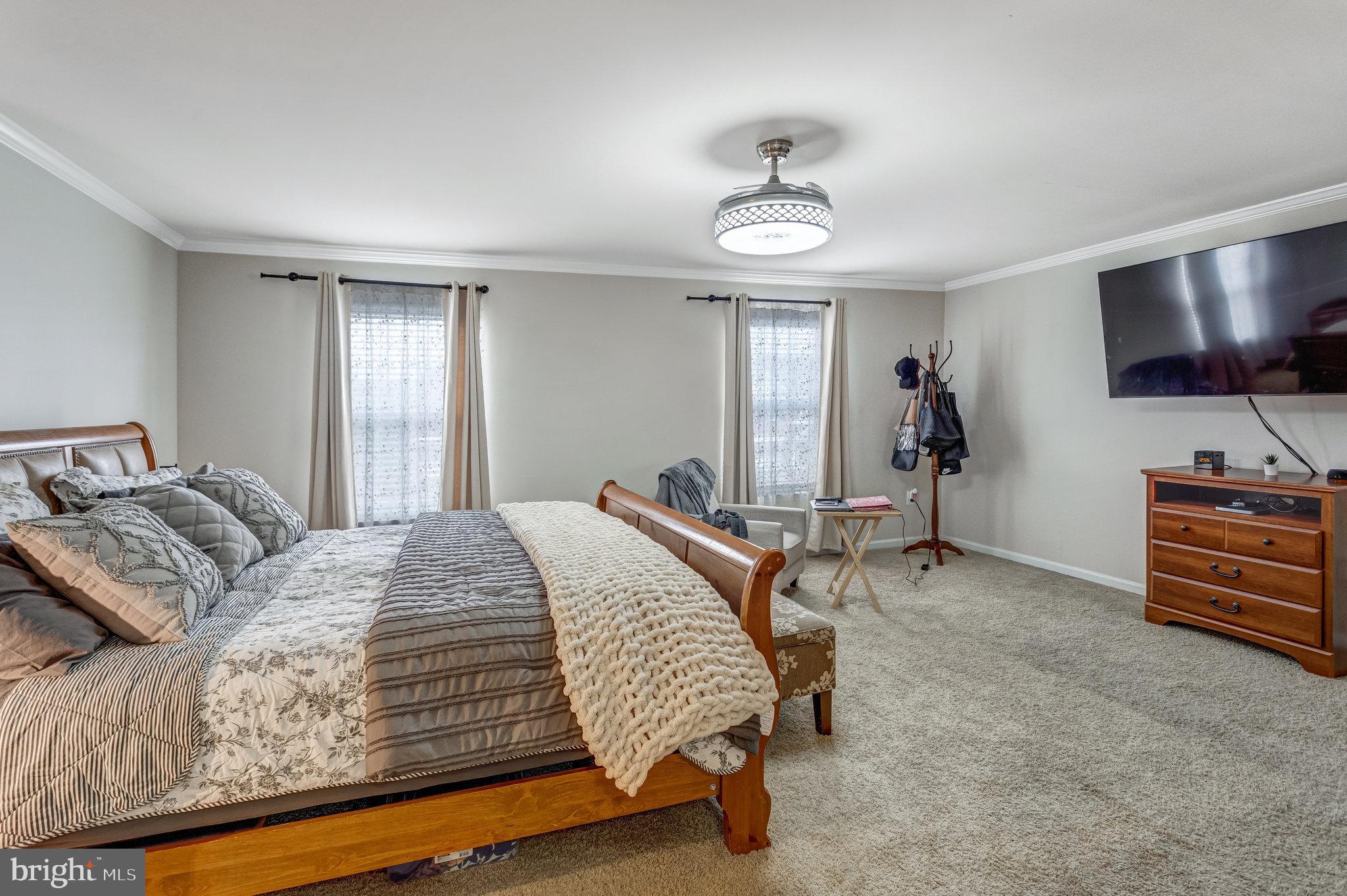 4287 Meyers Road Triangle, VA 22172 - Photo 29 of 51 a spacious bedroom with a bed and a flat screen tv