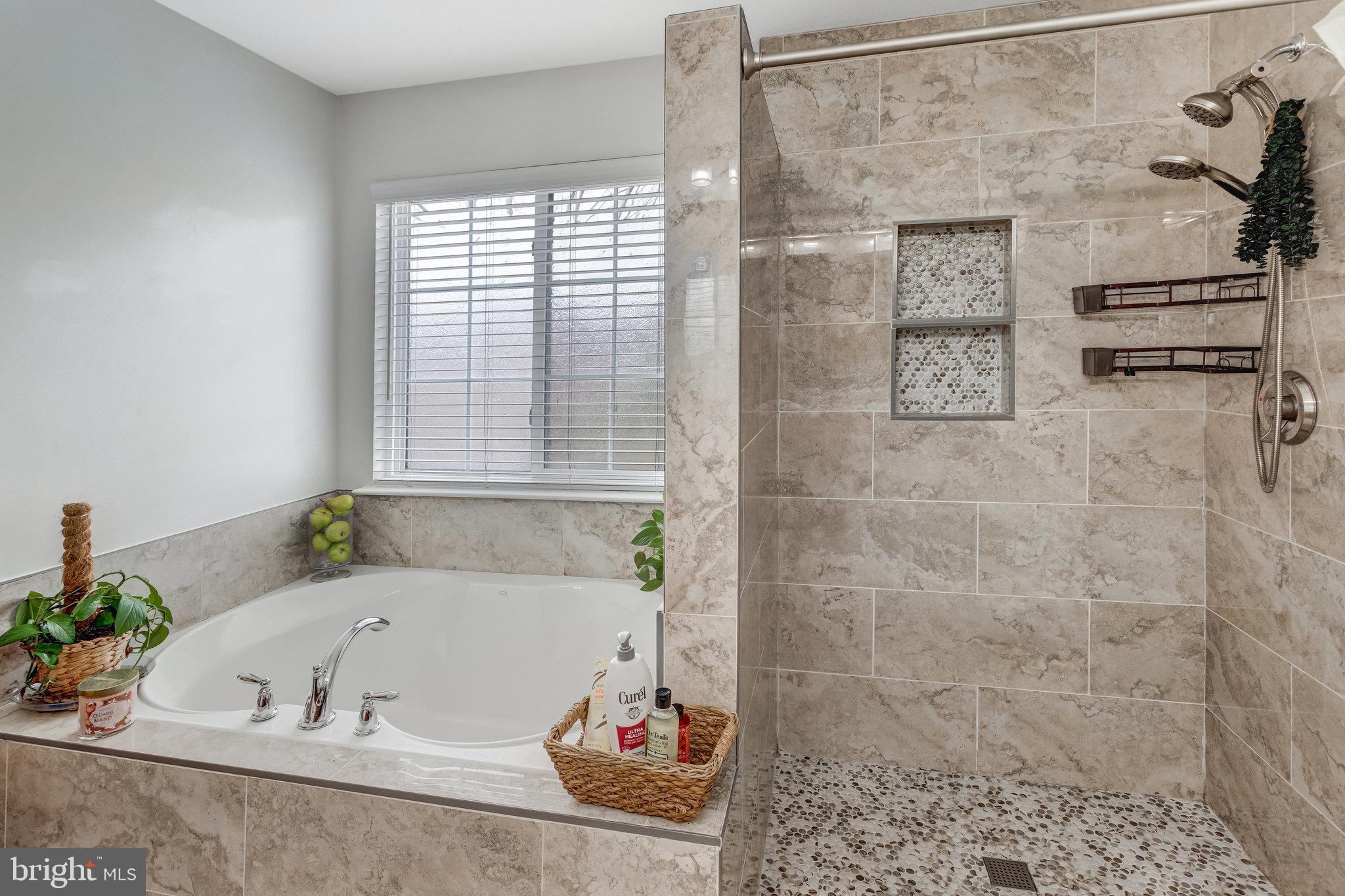 4287 Meyers Road Triangle, VA 22172 - Photo 33 of 51 a bath tub sitting in a bathroom next to a window