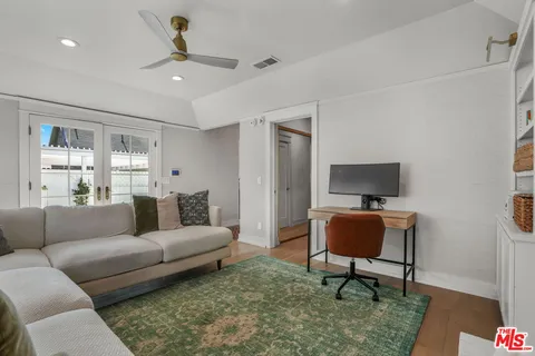 a bedroom with a large bed and a potted plant