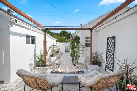 a living room with furniture fireplace and flat screen tv