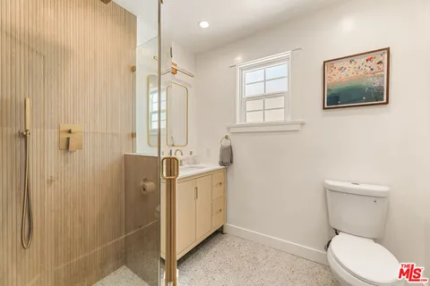 a bedroom with a bed and a mirror