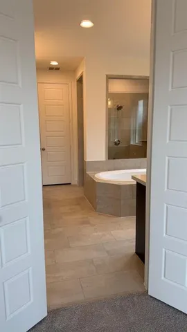 a bathroom with a sink a toilet a mirror and shower
