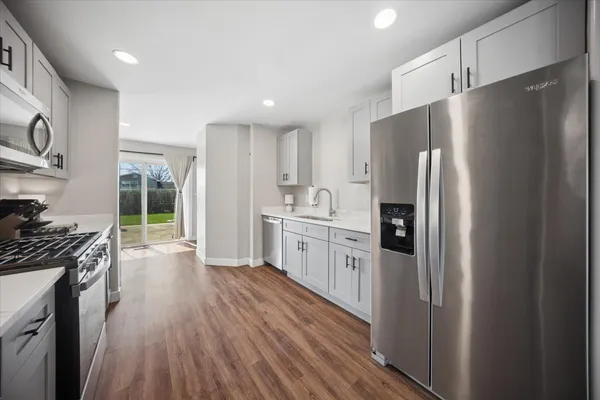 a kitchen with stainless steel appliances a refrigerator stove and sink