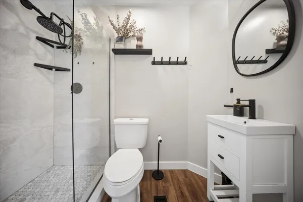 a bathroom with a toilet a sink and mirror