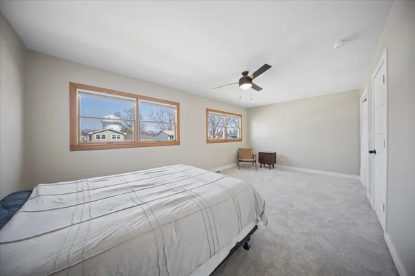 a bedroom with a large bed and a chandelier