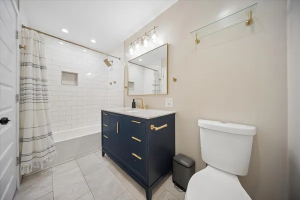 a bathroom with a sink vanity mirror and toilet