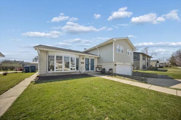 a view of a house with a yard and sitting area