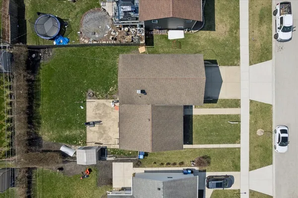 an aerial view of a house with a yard