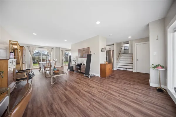 a view of a living room hardwood floor and a kitchen